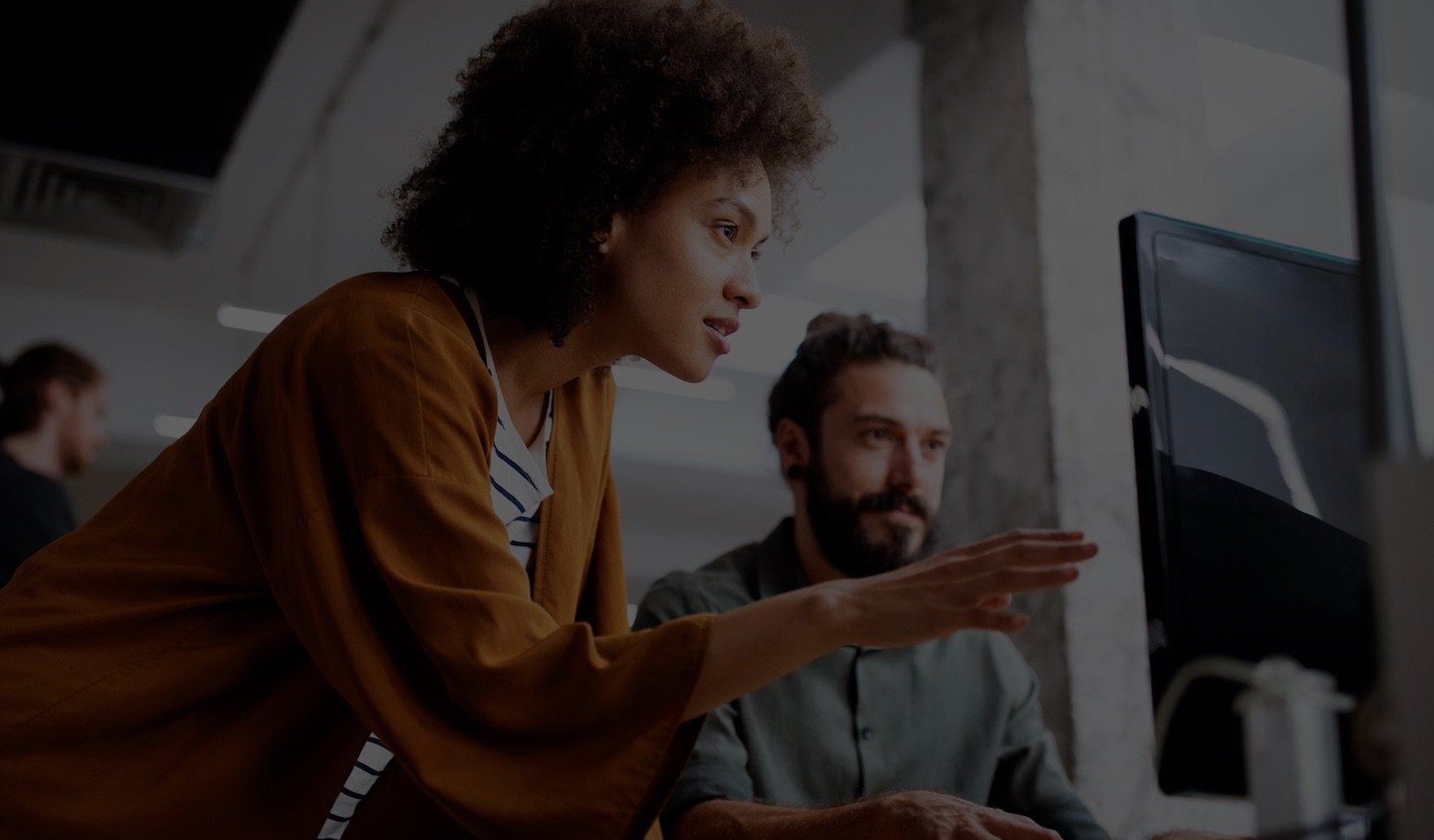 Two employees looking at a computer